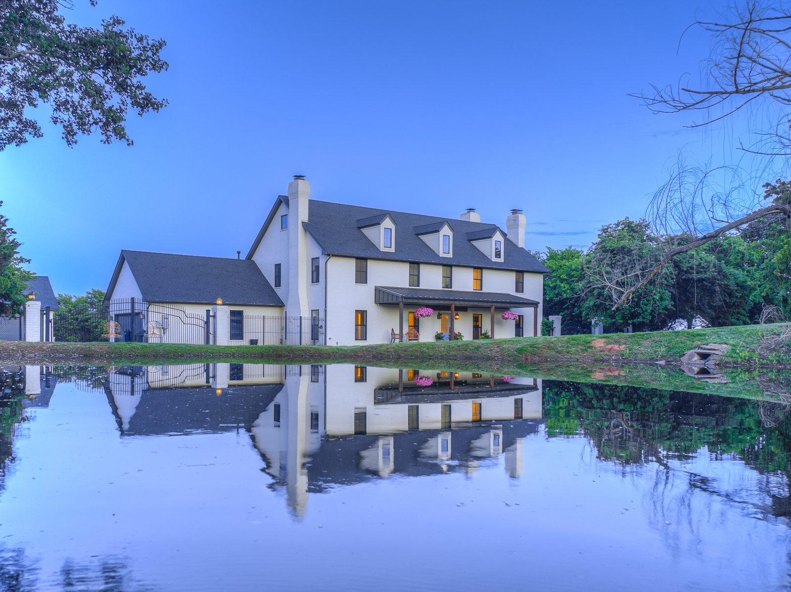 Twilight farmhouse reflected in a pond